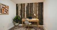 Weathered Wood wallpaper mural of dark peeling plank boards behind a wood desk in a small home office