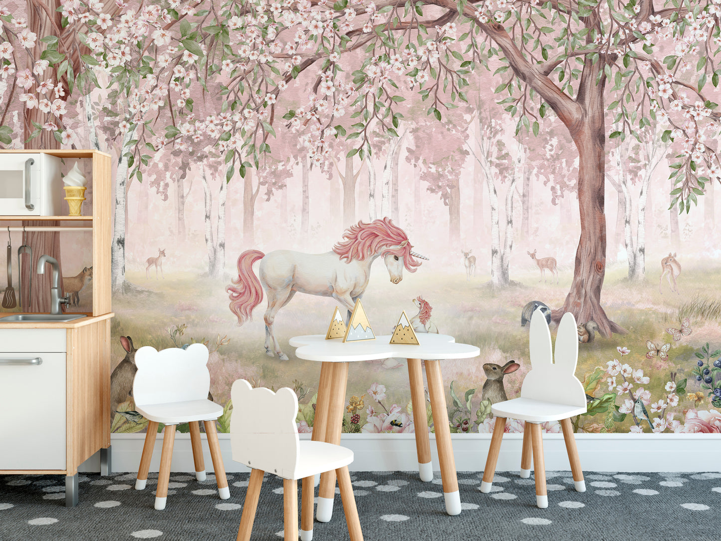 Magical Unicorn Forest Pink Wall Mural in a playroom with a small white table and two white bunny-eared chairs.