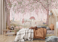 Peel and stick Unicorn Forest Pink Wall Mural in a kids bedroom with a wooden house bed and orange bedding.