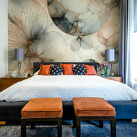 Soft botanical wallpaper for a quiet master bedroom with neutral bedding.