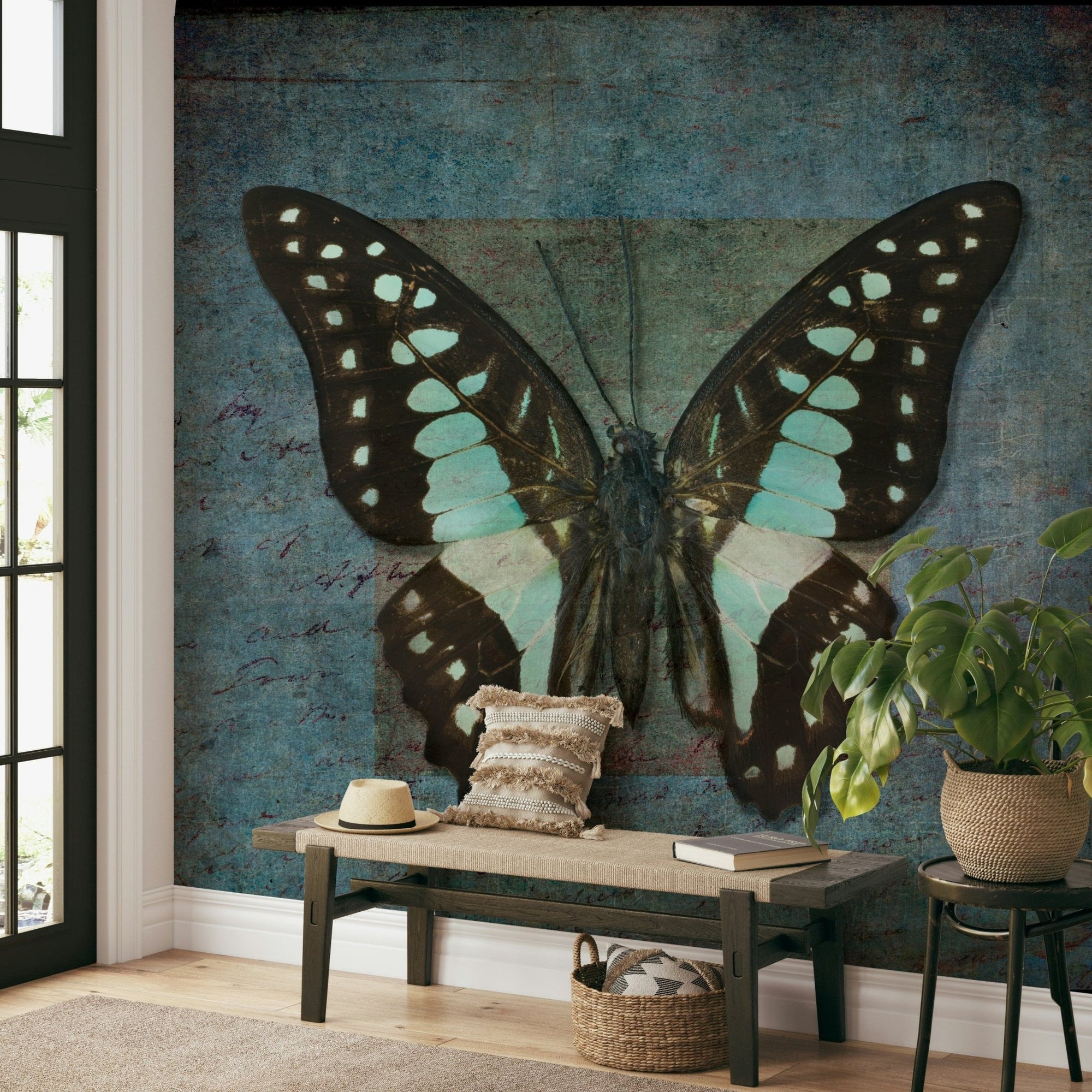 Whispering Butterfly Aura wallpaper mural of a teal and black butterfly behind a wood entryway bench and monstera