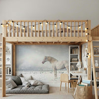 Snowdrift Horse wallpaper mural of a white horse in snow behind an oversized cream sofa in an open living room