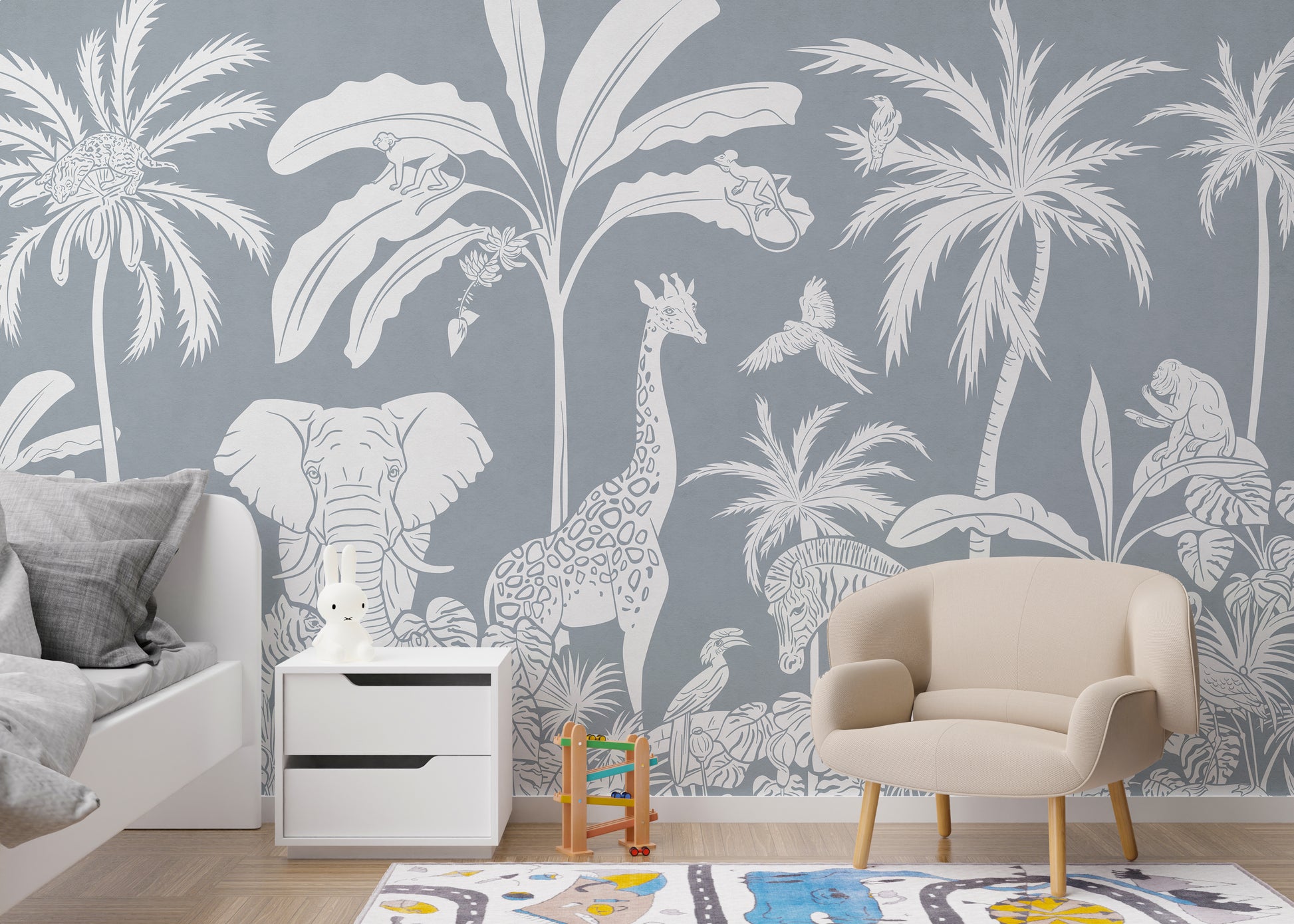 Temporary Monochrome Jungle Blue Wall Mural in a nursery with a white nightstand and a cozy beige armchair.