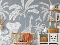 Removable self adhesive Monochrome Jungle Blue Wall Mural in a nursery with a rattan crib and storage shelving.