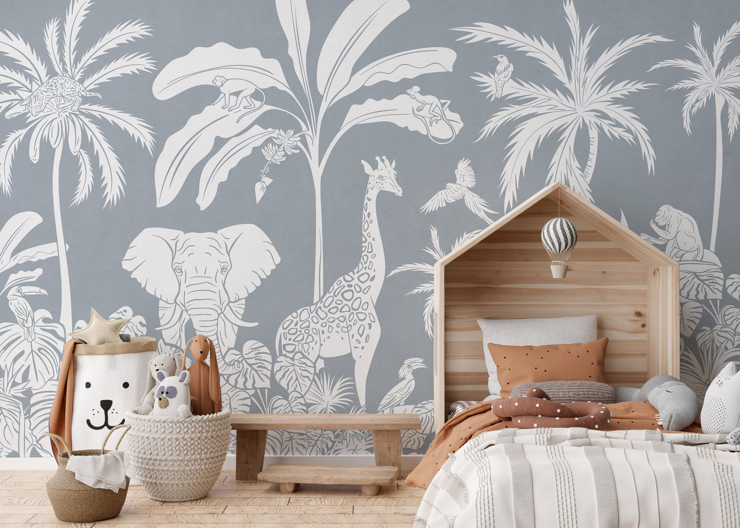 Monochrome Jungle Blue Wall Mural in a bedroom with a house bed and brown pillows using peel and stick material.