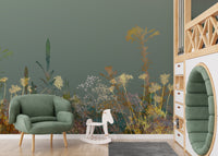 Wild Flower Design Art wallpaper mural in sage green behind a green armchair and white rocking horse in a kids room