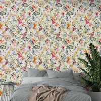 Gentle meadow landscape wallpaper for a study with a minimalist desk setup.