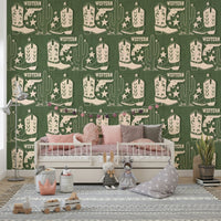 Rustic wallpaper mural with Western symbols including cowboy boots, pistols, and tall cacti.