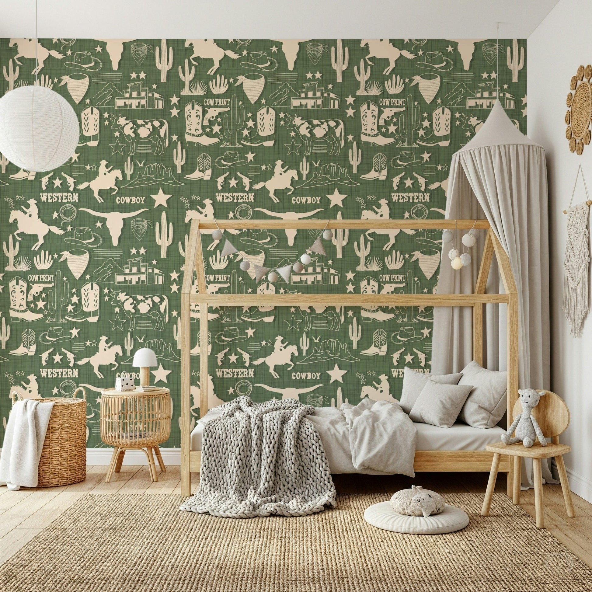 Cowboy-themed wallpaper mural with vintage-style western sketches on a warm green backdrop.