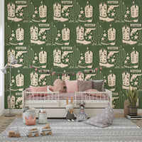 Rustic wallpaper mural with Western symbols including cowboy boots, pistols, and tall cacti.