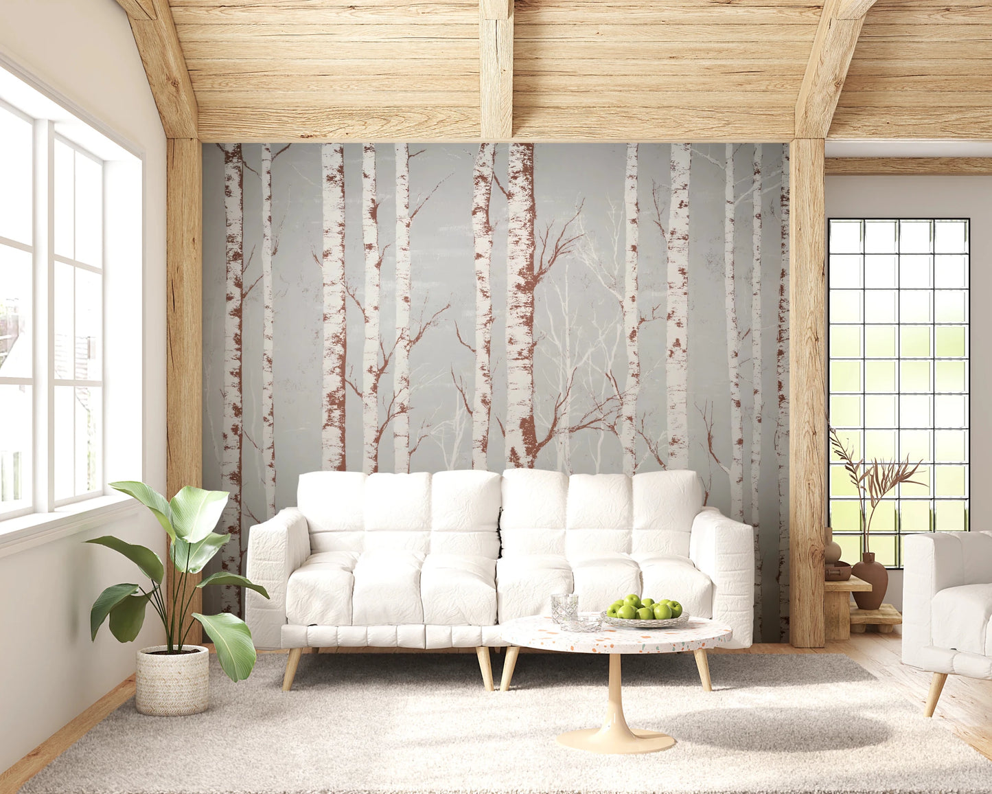 Winter Birch Beauty wallpaper mural with birch trunks on grey behind a white sofa and tulip table under wood beams in a living room
