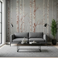 Winter Birch Beauty wallpaper mural with white birch trunks on grey behind a grey sofa flanked by black floor lamps in a living room