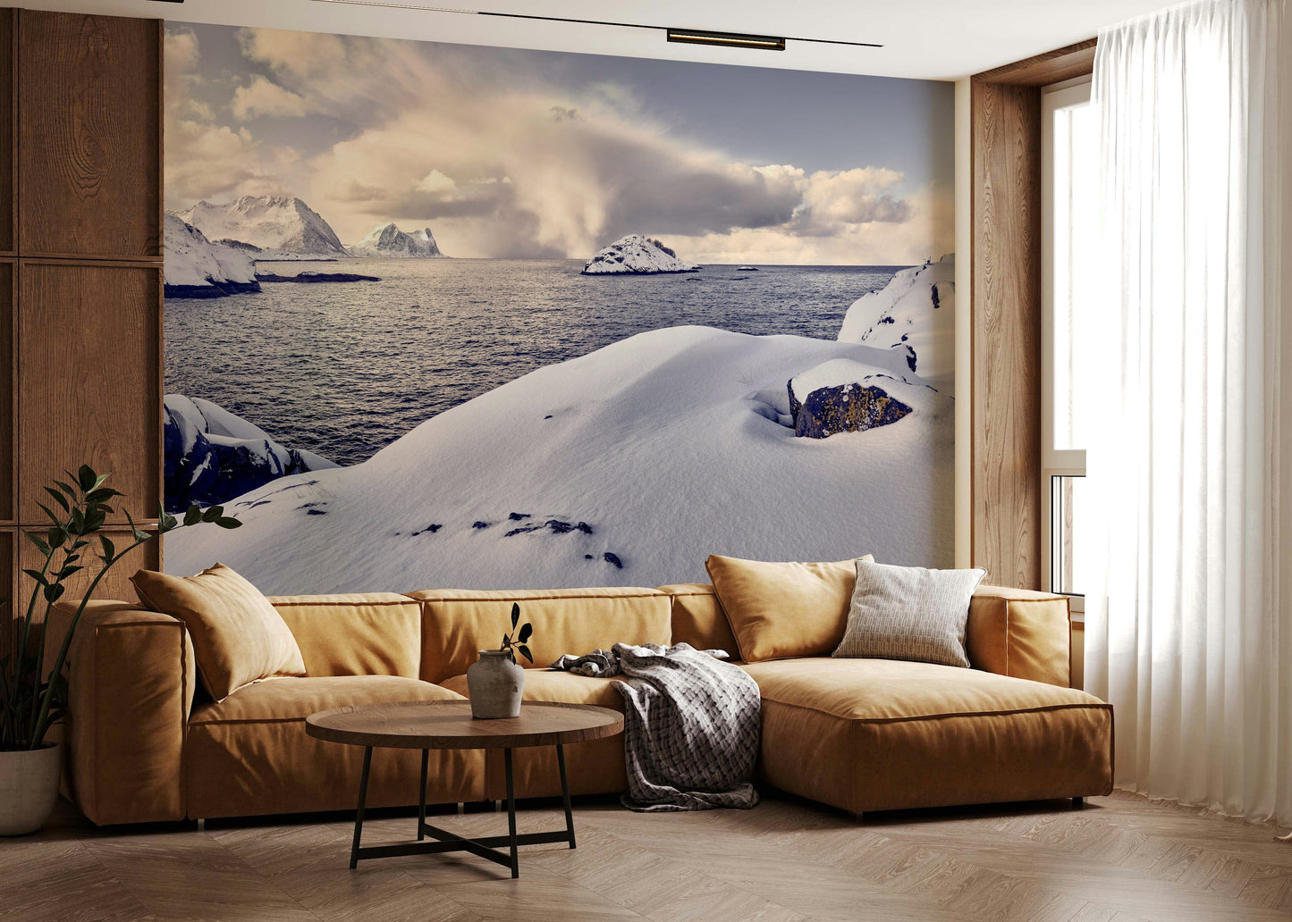 Arctic Dreamscape wallpaper mural of snowy shore and mountains behind a mustard sectional sofa in a living room
