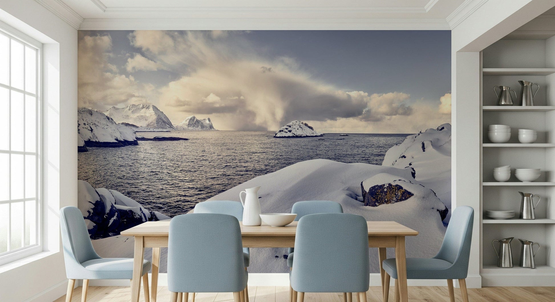 Arctic Dreamscape wallpaper mural of snowy arctic shore behind a wood dining table and dusty-blue chairs