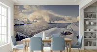 Arctic Dreamscape wallpaper mural of snowy arctic shore behind a wood dining table and dusty-blue chairs