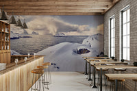 Arctic Dreamscape wallpaper mural of snowy shore and sea behind a wood bar and stools in a brick-walled cafe