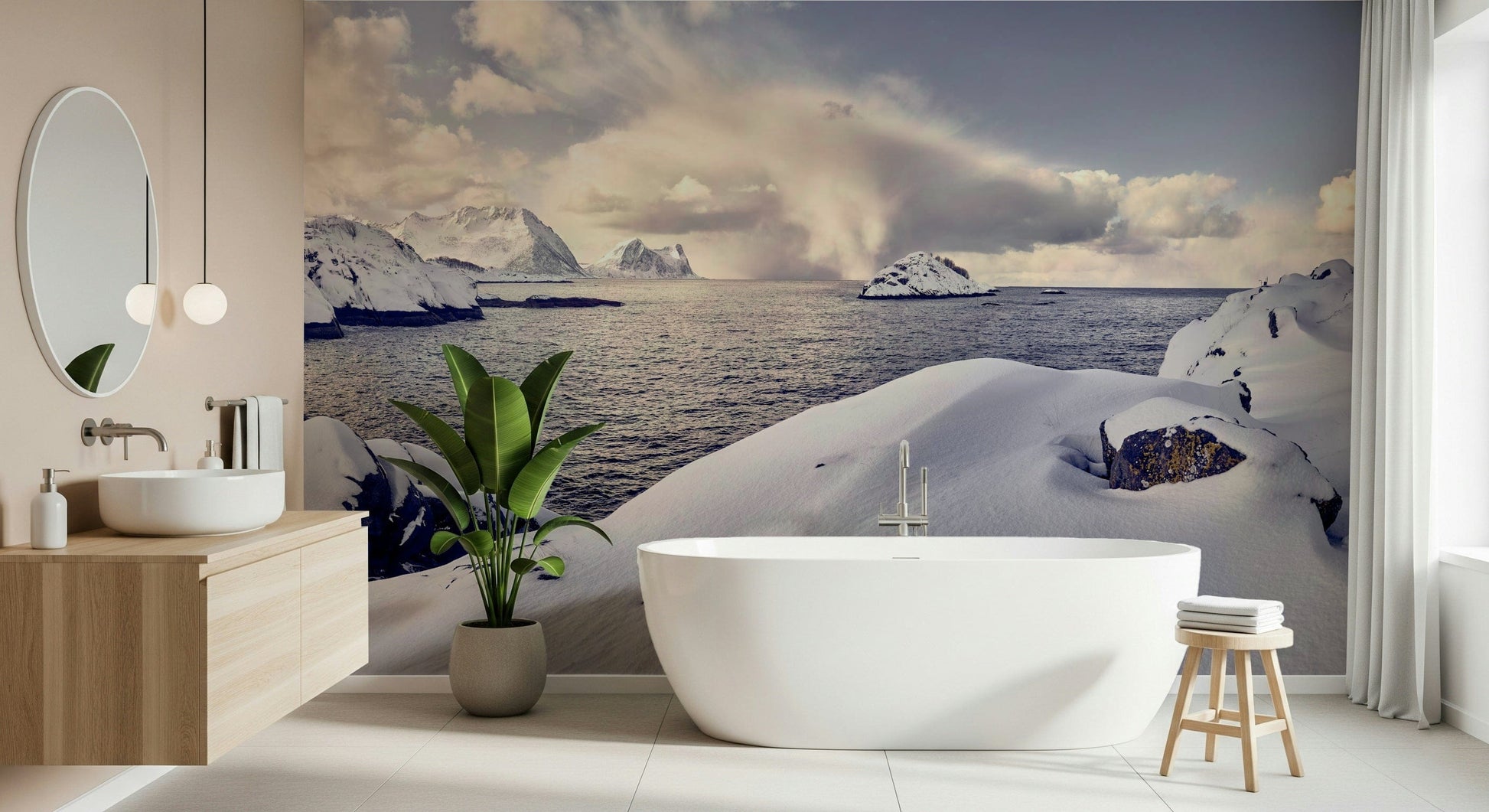 Arctic Dreamscape wallpaper mural of snowy sea and mountains behind a freestanding tub and wood vanity in a bathroom