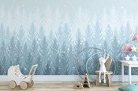 Winter Pines Forest wallpaper in soft blue with falling snow behind a wooden toy pram in a child's nursery