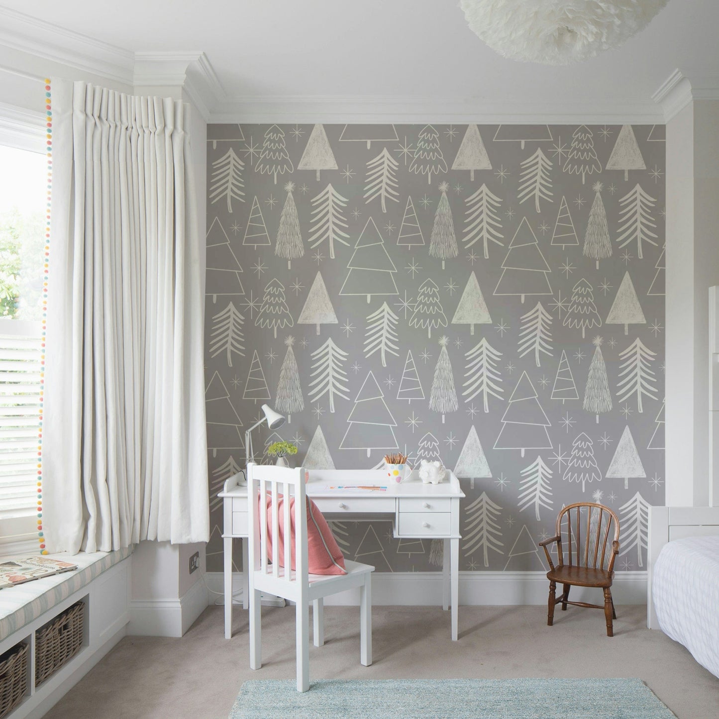 A gentle gray wallpaper featuring playful sketched evergreens and star shapes.