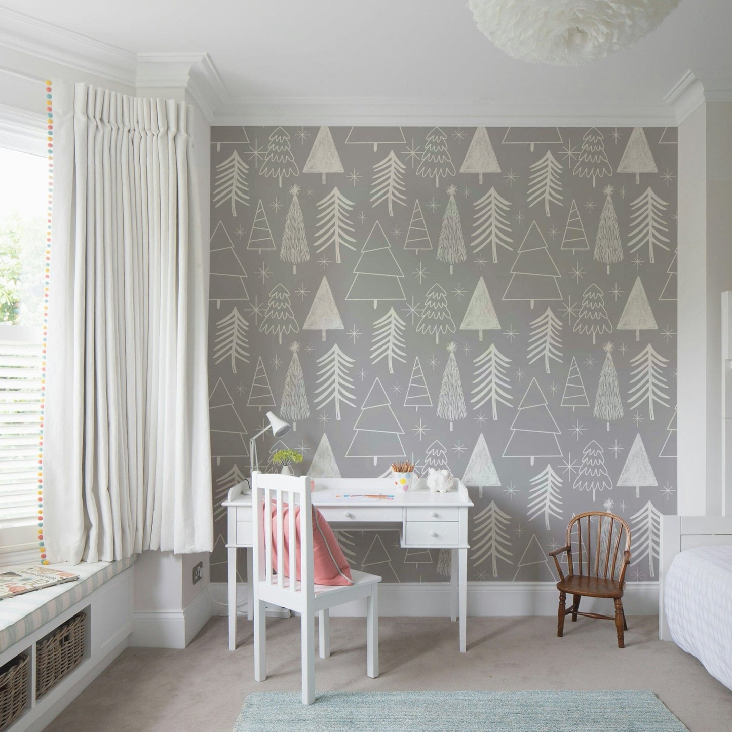 A gentle gray wallpaper featuring playful sketched evergreens and star shapes.