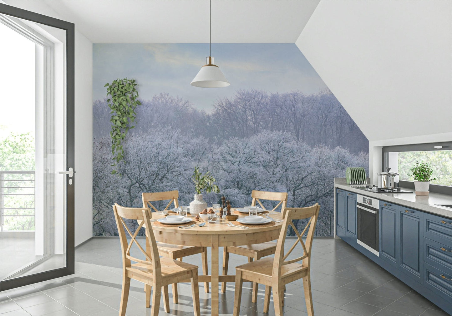 Winter's Whispers wallpaper mural of a winter treeline in a kitchen with navy-blue cabinets and a round wood table