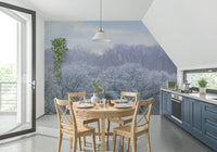 Winter's Whispers wallpaper mural of a winter treeline in a kitchen with navy-blue cabinets and a round wood table