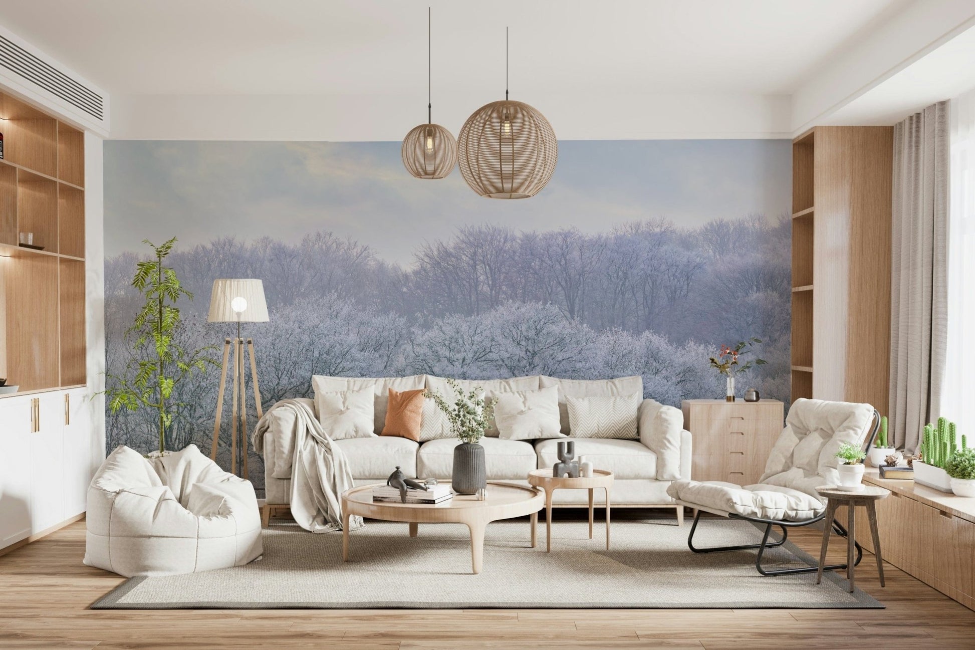 Winter's Whispers wallpaper mural of a frosted treeline behind a cream sofa and white beanbag in a bright living room