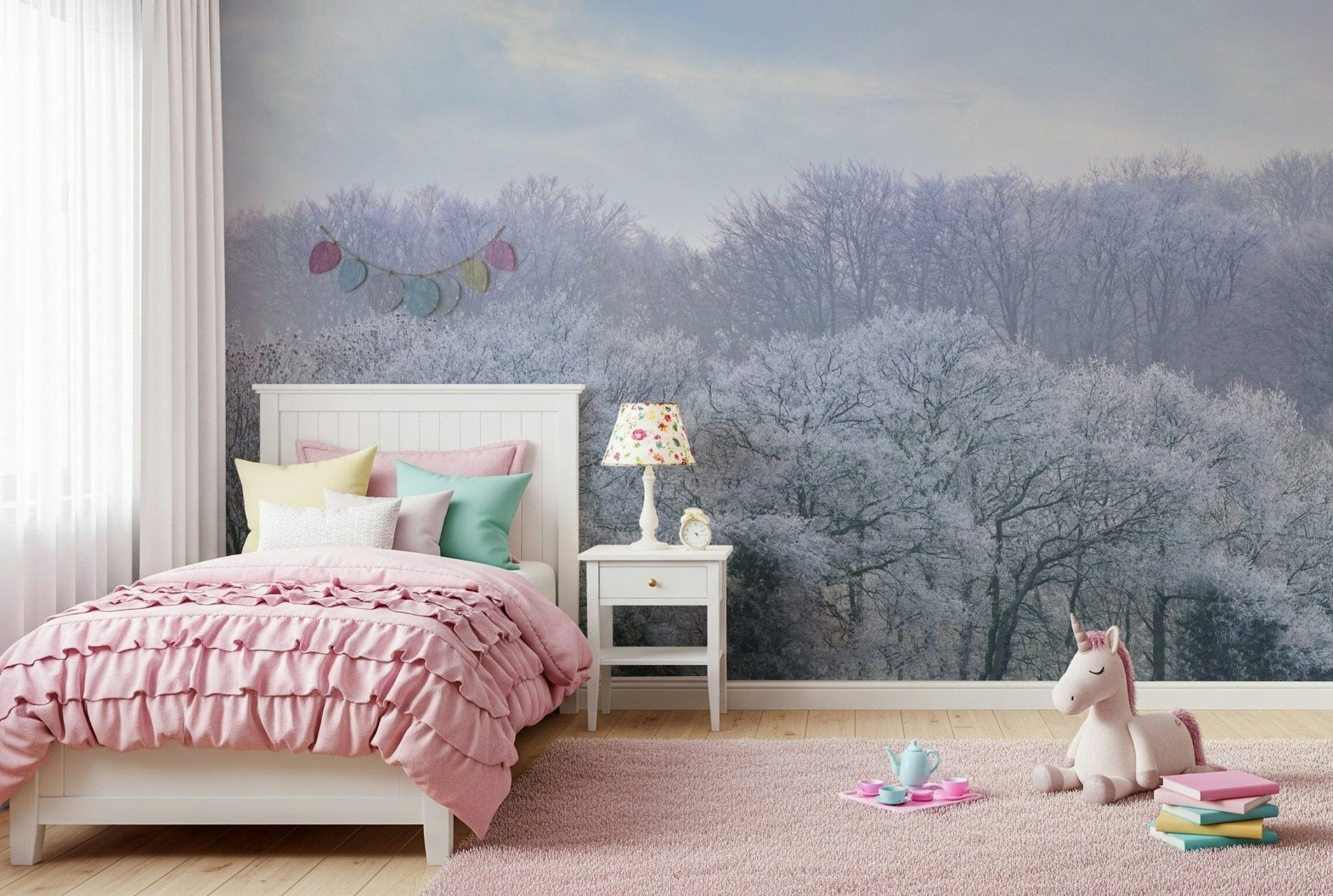 Winter's Whispers wallpaper mural of a snowy winter forest behind a pink ruffled bed and unicorn toy in a girl's room