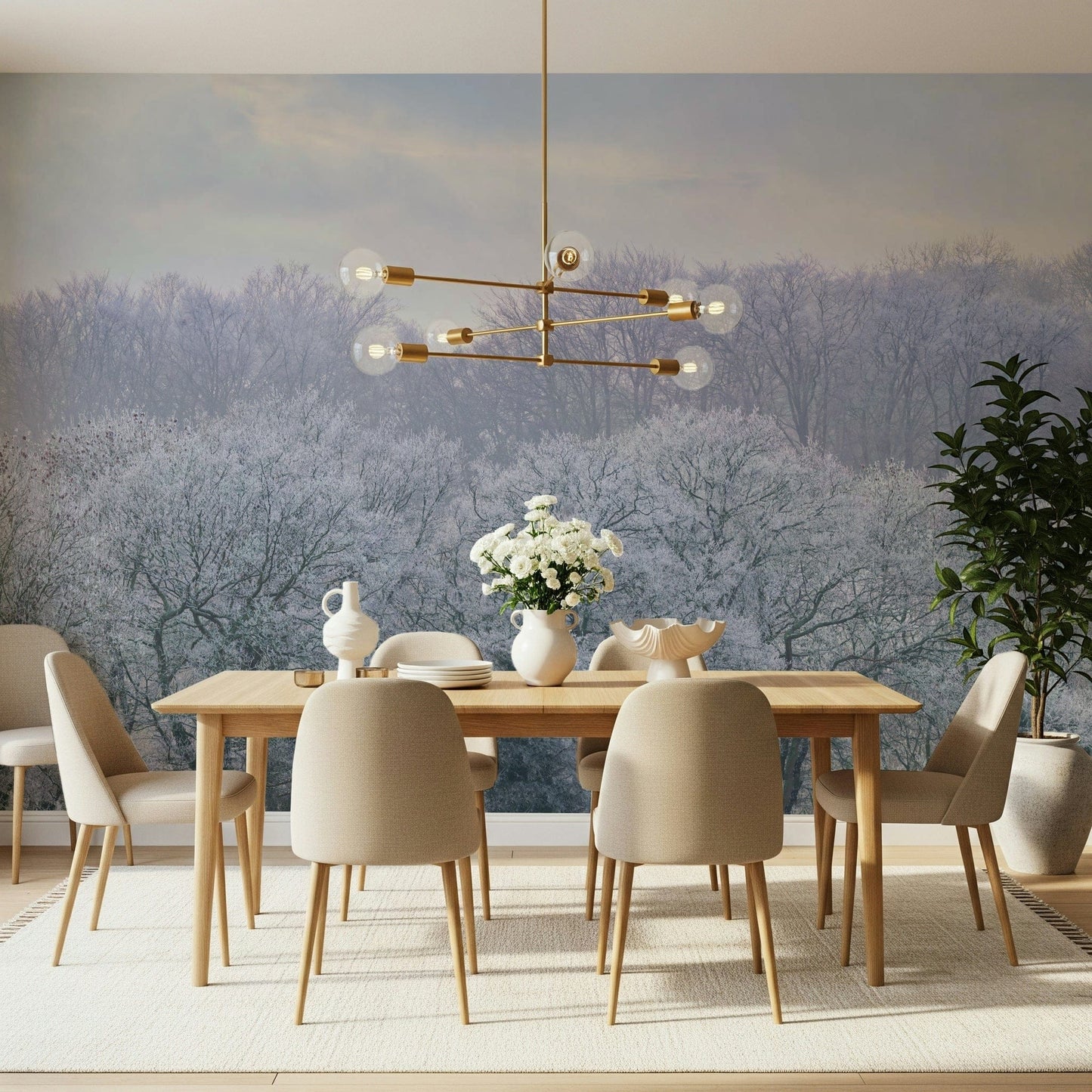 Winter's Whispers wallpaper mural of a misty frosted woodland behind a wood dining table and beige chairs