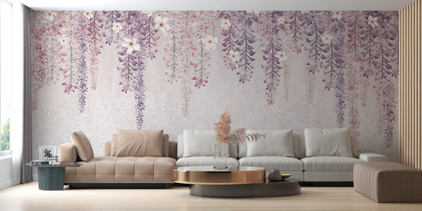 Wisteria Watercolor wallpaper mural in purple and pink behind a beige and grey sectional sofa