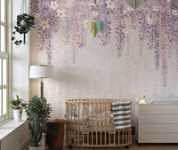 Wisteria Watercolor wallpaper mural in pink and purple above a wooden crib in a bright nursery