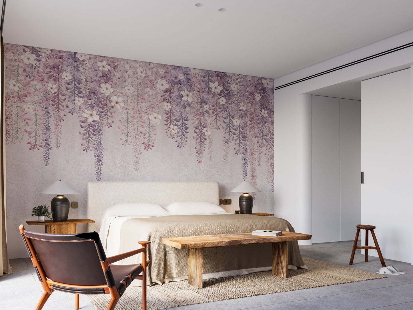 Wisteria Watercolor wallpaper mural of cascading purple blooms behind a cream bed in a bedroom