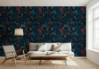 Wonderforest wallpaper of navy blooms and birds behind a white sofa and woven lounge chair in a living room