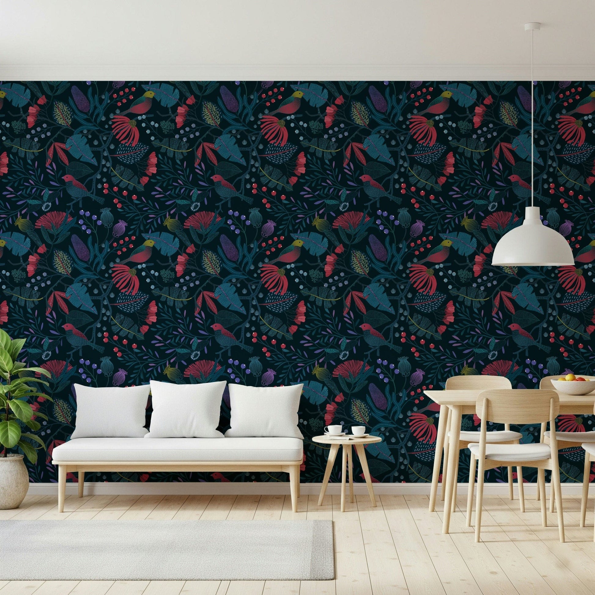 Wonderforest wallpaper in navy and crimson tones behind a white bench and light wood dining set