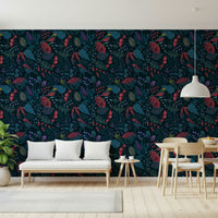 Wonderforest wallpaper in navy and crimson tones behind a white bench and light wood dining set