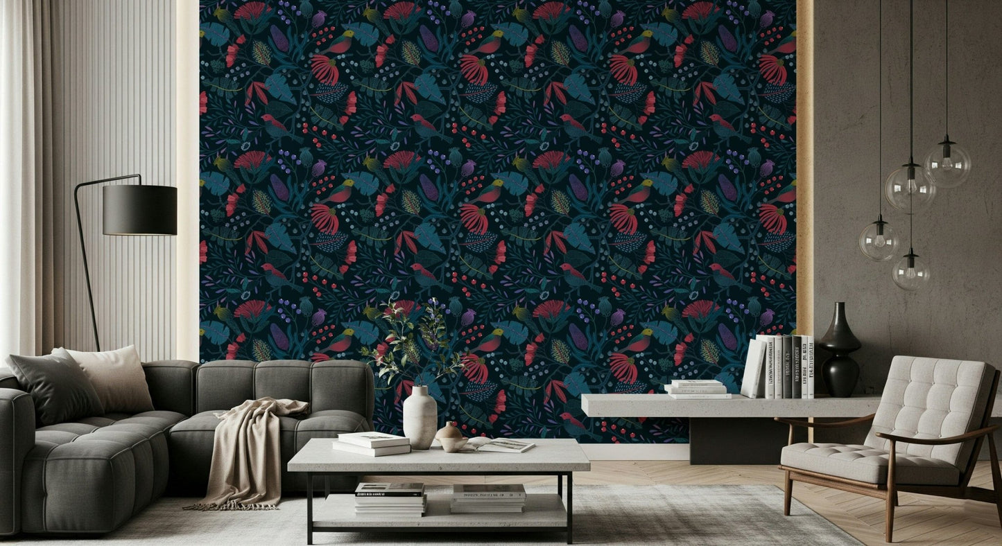 Wonderforest wallpaper in dark navy florals behind a grey sofa and tufted armchair in a sunlit living room