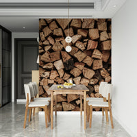 Woodpile Texture wallpaper mural of stacked logs behind a wood dining table and beige chairs