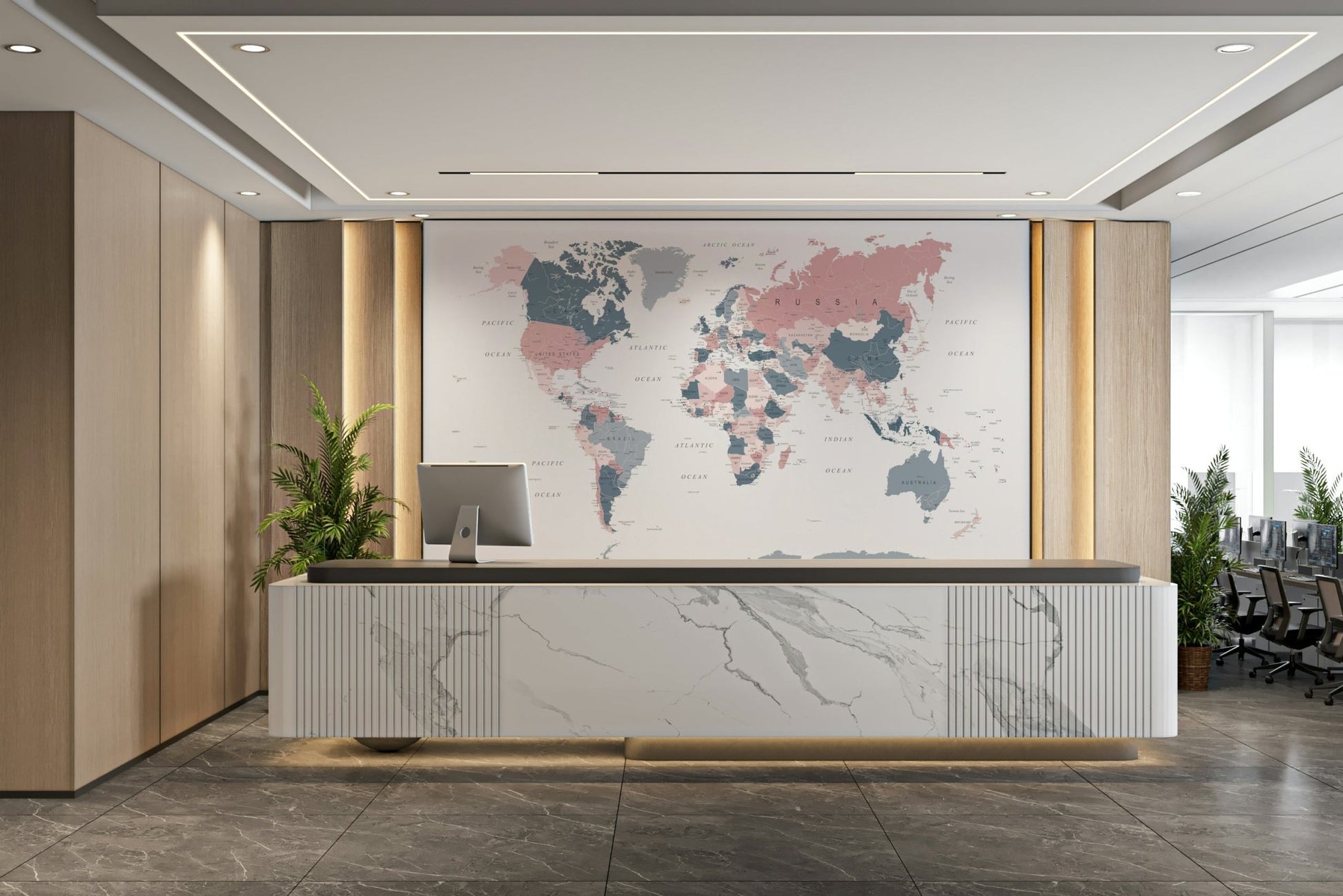 World Map Blush Pink and Indigo wallpaper mural behind a marble reception desk and ferns in an office lobby