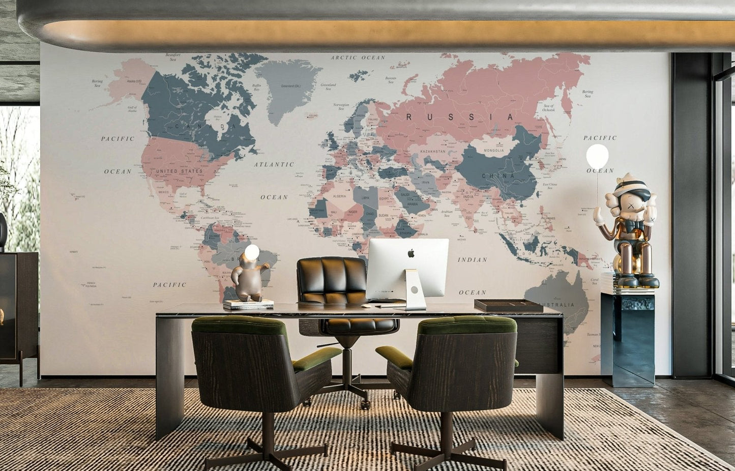 World Map Blush Pink and Indigo wallpaper mural behind a dark executive desk in a home office with armchairs