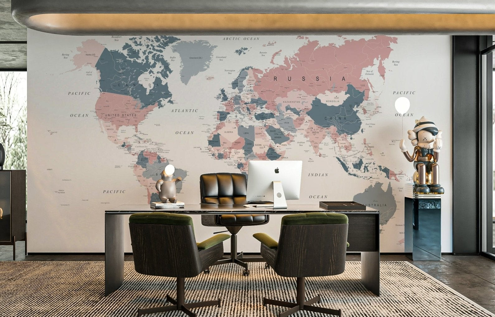 World Map Blush Pink and Indigo wallpaper mural behind a dark executive desk in a home office with armchairs