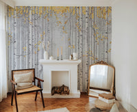 Yellow Leaves and Gray Birch Trees wallpaper mural behind a white fireplace and cane chair in a cozy living room