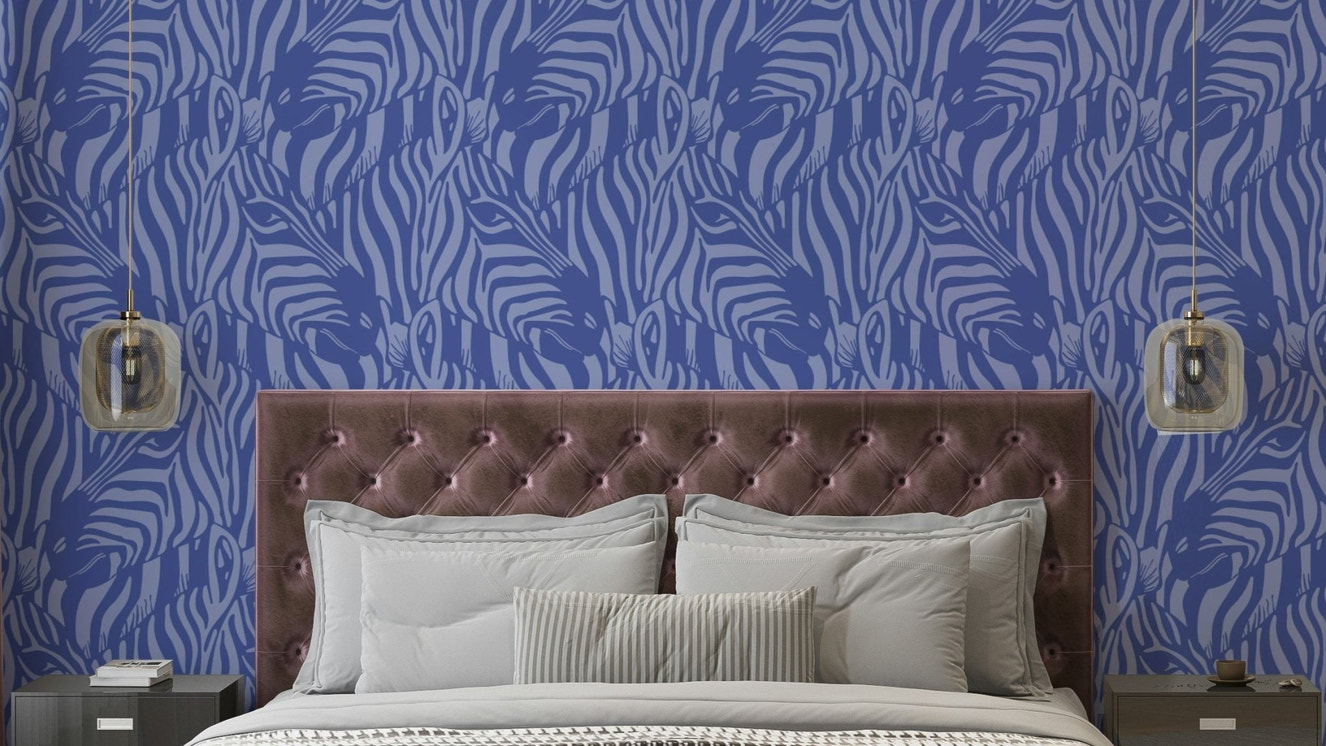A wall mural of a zebra herd with artistic stripes.

