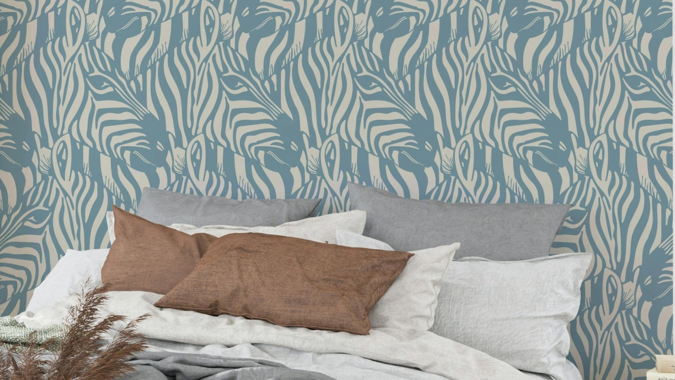 A wall mural of a zebra herd with artistic stripes.

