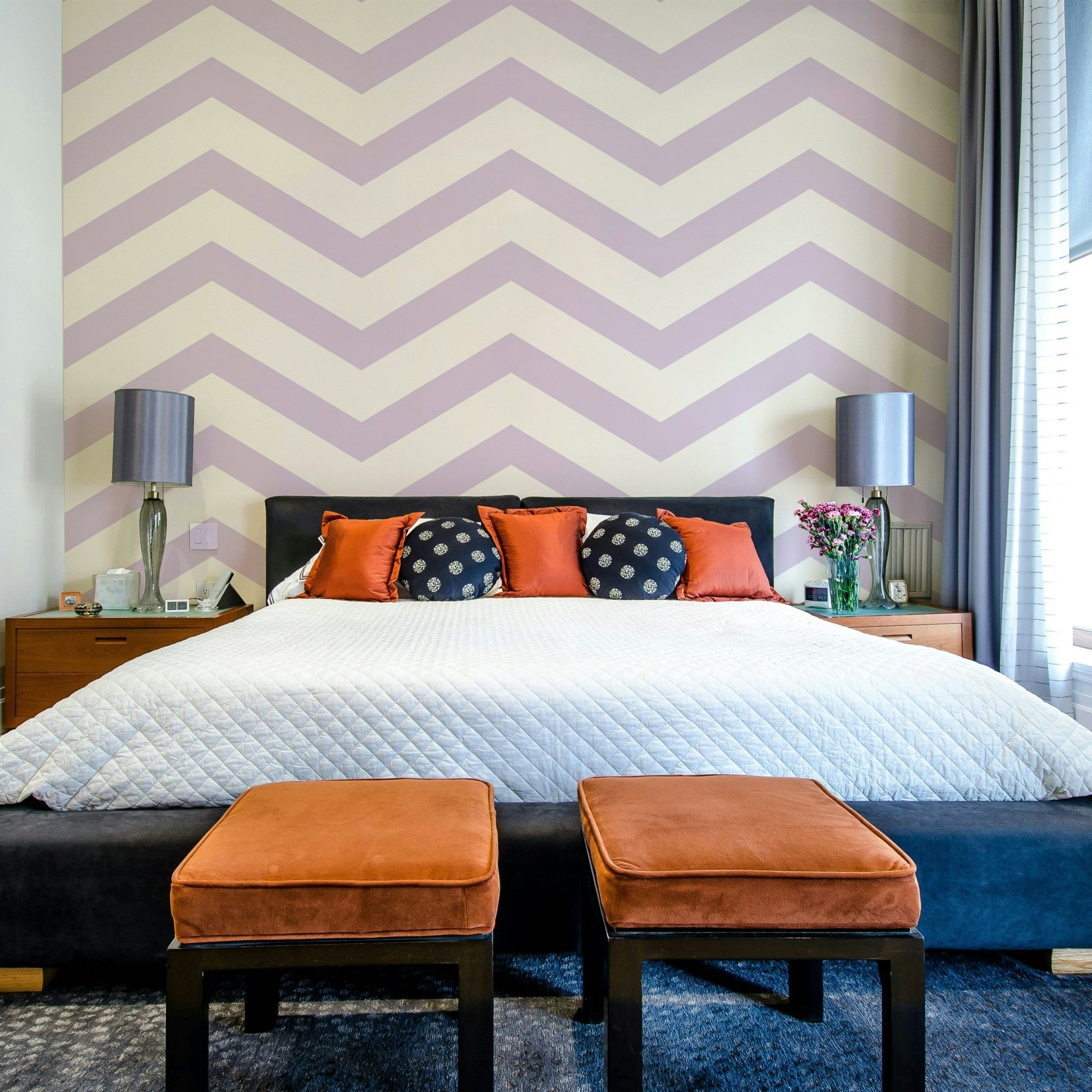 Lilac zigzag wallpaper pattern on a light neutral background.

